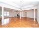 Spacious living room with hardwood floors, pillars, and a decorative chandelier at 10034 Bishops Gate Blvd, Pineville, NC 28134