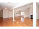 Bright, open living room with gleaming hardwood floors, columns, and a cozy fireplace at 10034 Bishops Gate Blvd, Pineville, NC 28134