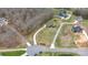 Aerial view showing an expansive property with a circular driveway, mature trees, and lush green lawn at 1011 Duntov Dr, Monroe, NC 28110