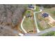 Aerial view of a landscaped property with a circular driveway, lush lawn, and well-maintained yard at 1011 Duntov Dr, Monroe, NC 28110