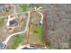 Aerial view showcasing property boundaries, circular driveway, spacious lawn, and mature trees at 1011 Duntov Dr, Monroe, NC 28110
