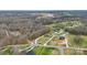 Aerial view of a landscaped property in a neighborhood with a circular driveway and mature trees at 1011 Duntov Dr, Monroe, NC 28110