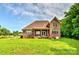 Beautiful brick home with a covered back porch overlooking a lush lawn at 1011 Duntov Dr, Monroe, NC 28110