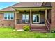 Relaxing back porch with seating and a view of the landscaped backyard at 1011 Duntov Dr, Monroe, NC 28110