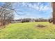 Expansive backyard featuring a lush green lawn, mature trees, and well maintained landscaping at 1011 Duntov Dr, Monroe, NC 28110