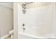 Bright white tiled bathtub with shower head and metal caddy provides plenty of space at 1011 Duntov Dr, Monroe, NC 28110