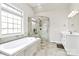 Bright bathroom with soaking tub, glass shower, and double vanity at 1011 Duntov Dr, Monroe, NC 28110