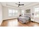 Light-filled bedroom featuring hardwood floors, ceiling fan and large windows at 1011 Duntov Dr, Monroe, NC 28110