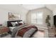 Comfortable bedroom with a plush bed, neutral tones, and a window providing natural light at 1011 Duntov Dr, Monroe, NC 28110