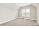 Bedroom featuring neutral walls and carpet, and a window that provides natural light at 1011 Duntov Dr, Monroe, NC 28110