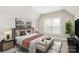 Stylishly furnished bedroom with a comfortable bed, modern decor, and bright natural light at 1011 Duntov Dr, Monroe, NC 28110