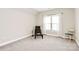 Cozy bedroom features neutral carpet and wall paint with a window and seating at 1011 Duntov Dr, Monroe, NC 28110