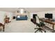 Spacious bonus room with sofa, desk, and television, ideal for entertainment and work at 1011 Duntov Dr, Monroe, NC 28110