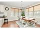 Charming dining area featuring natural light, a rustic wooden table, and white chairs at 1011 Duntov Dr, Monroe, NC 28110