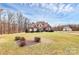 Charming brick home with a well-manicured lawn and mature trees in a lovely landscape at 1011 Duntov Dr, Monroe, NC 28110