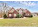 Charming brick home with a well-manicured lawn and beautiful landscaping at 1011 Duntov Dr, Monroe, NC 28110