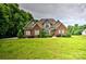 Charming brick home with well-manicured lawn and lush landscaping at 1011 Duntov Dr, Monroe, NC 28110