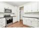 Clean kitchen features white cabinets, granite countertops, and stainless steel appliances at 1011 Duntov Dr, Monroe, NC 28110