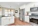 This kitchen has granite countertops, white cabinets, and stainless steel appliances at 1011 Duntov Dr, Monroe, NC 28110