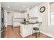 Well-lit kitchen features granite countertops, white cabinets, and a breakfast bar at 1011 Duntov Dr, Monroe, NC 28110