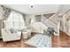 Cozy living room with large windows, stylish decor, and a staircase at 1011 Duntov Dr, Monroe, NC 28110