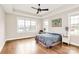 Bright main bedroom with tray ceiling, ceiling fan, and large windows with natural light at 1011 Duntov Dr, Monroe, NC 28110