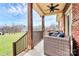 Covered porch with rustic wooden columns, outdoor seating, and ceiling fan for relaxation at 1011 Duntov Dr, Monroe, NC 28110