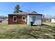 Exterior of brick house with a small backyard and storage building at 104 N 9Th St, Bessemer City, NC 28016