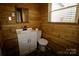 Bathroom featuring a vanity, toilet, and wood paneled walls with window at 104 N 9Th St, Bessemer City, NC 28016