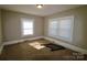 A simple carpeted bedroom with two bright windows and neutral paint. Ready for your personal touches at 104 N 9Th St, Bessemer City, NC 28016