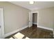 Bedroom with hardwood floors, neutral paint, and a doorway leading to the hallway at 104 N 9Th St, Bessemer City, NC 28016