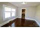 Bright dining area featuring hardwood floors, neutral paint, and bright windows and adjacent kitchen view at 104 N 9Th St, Bessemer City, NC 28016