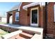 Close-up view of a brick home's front entrance featuring a white-trimmed glass door and canopy at 104 N 9Th St, Bessemer City, NC 28016