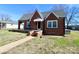 Charming brick home with a covered front porch and well-maintained lawn under a clear, blue sky at 104 N 9Th St, Bessemer City, NC 28016