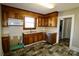 Traditional kitchen with wooden cabinets, appliances, and vinyl flooring at 104 N 9Th St, Bessemer City, NC 28016