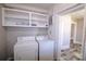 Laundry area with washer, dryer and shelving for organized space at 104 N 9Th St, Bessemer City, NC 28016