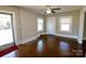 Bright living room with hardwood floors, neutral paint, classic ceiling fan, and plentiful windows at 104 N 9Th St, Bessemer City, NC 28016