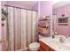 Cozy bathroom with lavender walls, a decorative shower curtain, and a floating shelves at 128 S Arcadian Way, Mooresville, NC 28117