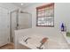 Clean and bright bathroom showcasing a luxurious soaking tub and separate glass shower at 128 S Arcadian Way, Mooresville, NC 28117