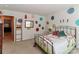 Bright bedroom featuring decoratively painted walls, a metal frame bed, and carpeted floors at 128 S Arcadian Way, Mooresville, NC 28117