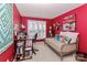 Red-themed bedroom featuring a daybed, large window, and desk with ample storage at 128 S Arcadian Way, Mooresville, NC 28117