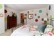 Bright bedroom featuring decoratively painted walls, a wooden dresser, and carpeted floors at 128 S Arcadian Way, Mooresville, NC 28117