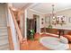 Open dining room with hardwood floors, chandelier, and decorative screen at 128 S Arcadian Way, Mooresville, NC 28117