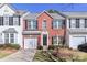 Attractive brick townhouse with black shutters, attached garage, and well-maintained front lawn at 128 S Arcadian Way, Mooresville, NC 28117