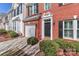 Close up of a charming two-story brick townhome with attached garage and black shutters at 128 S Arcadian Way, Mooresville, NC 28117