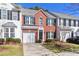 Charming brick townhouse with an attached garage, manicured landscaping, and a welcoming front door at 128 S Arcadian Way, Mooresville, NC 28117
