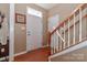Bright foyer featuring hardwood floors, a staircase, and a coat rack at 128 S Arcadian Way, Mooresville, NC 28117