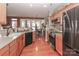 Well-lit kitchen featuring stainless steel appliances, wood cabinets, and hardwood flooring at 128 S Arcadian Way, Mooresville, NC 28117