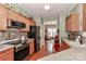 Well-lit kitchen featuring stainless steel appliances, wood cabinets, and hardwood flooring at 128 S Arcadian Way, Mooresville, NC 28117