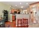 Kitchen with light wood cabinets, bar seating and stainless appliances overlooks dining area at 128 S Arcadian Way, Mooresville, NC 28117